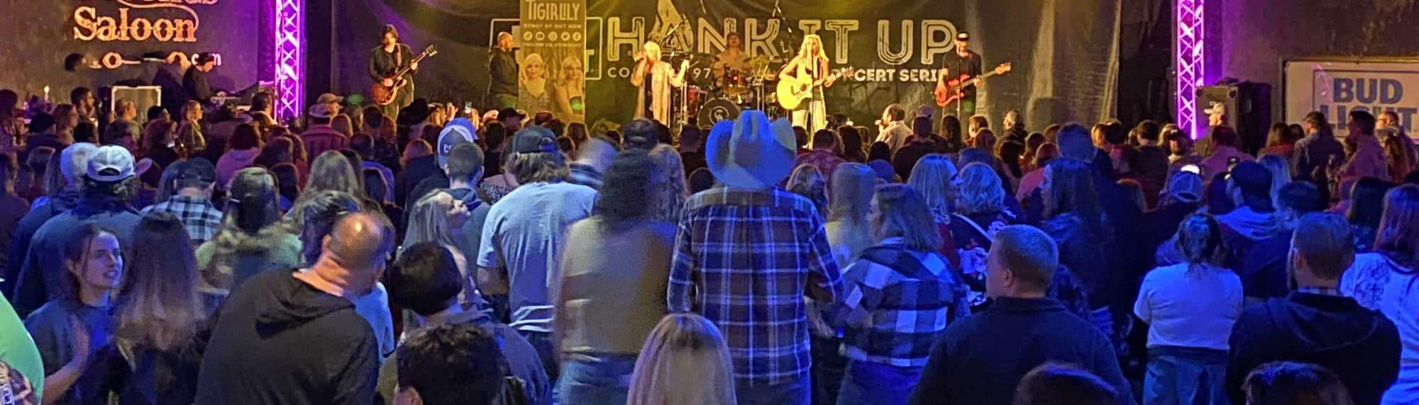 country concert with fans wearing cowboy hats Bakersfield