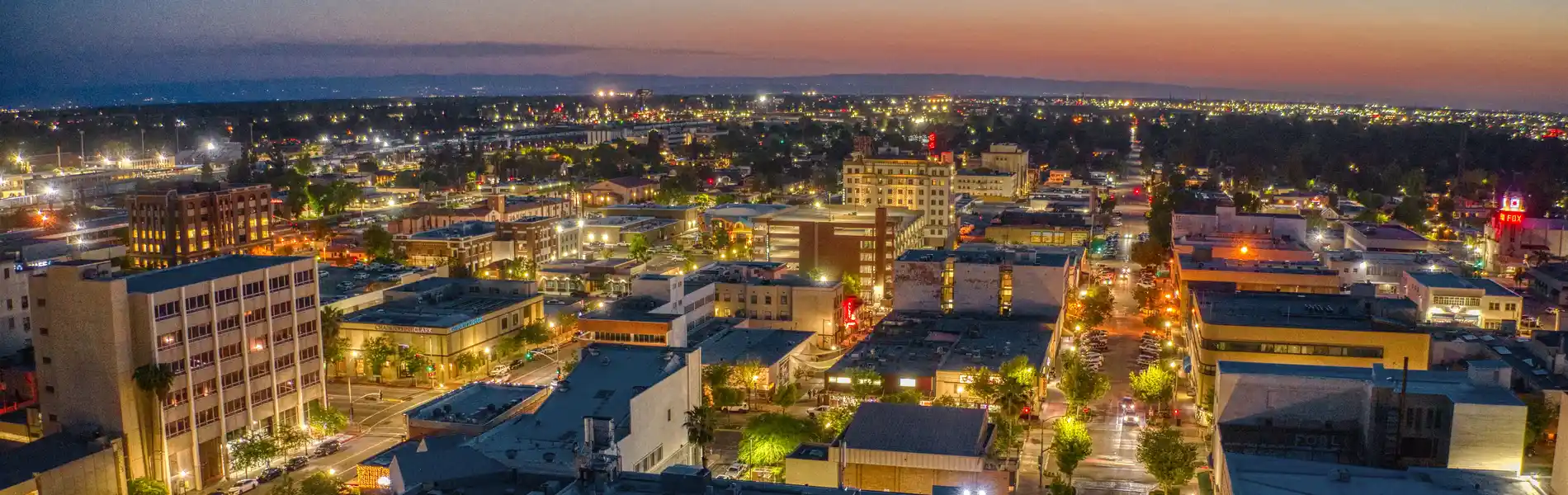 Neon color image of a band playing and people singing along